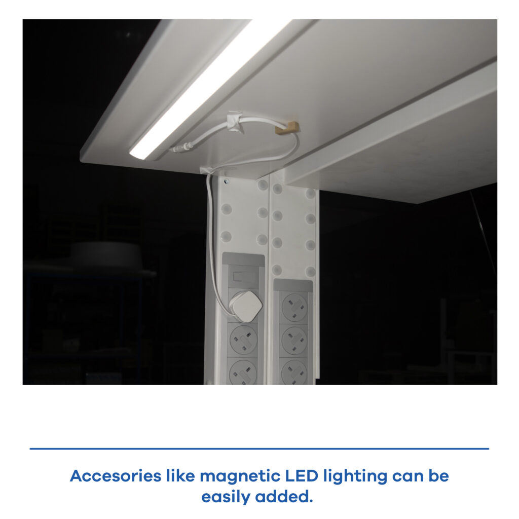 Close-up detail of the integrated LED lighting accessory turned on under the shelf of a Barcelona laboratory workstation.